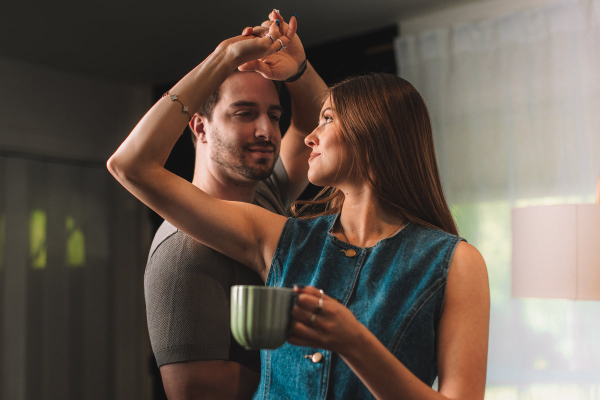 Man and woman dancing together in a home setting