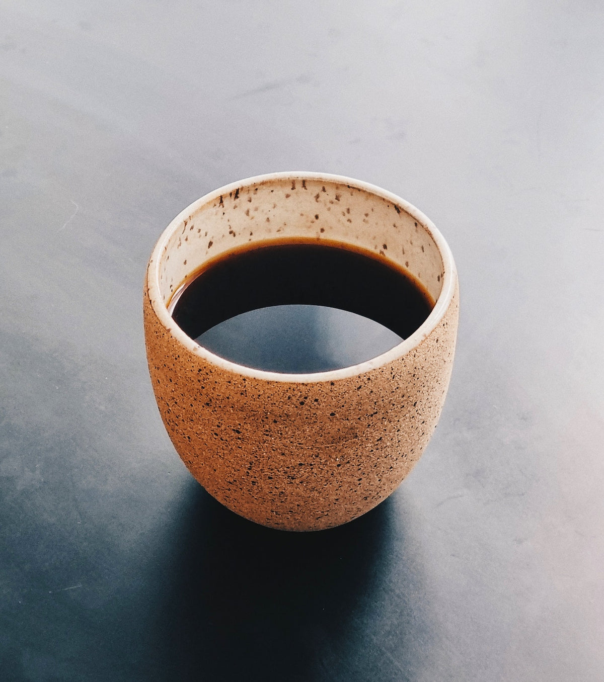 a cup of brewed dark roast drip coffee